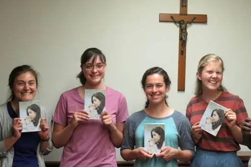 Young women posing with copies of Discerning Religious Life book.