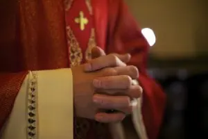 Priest praying hands.