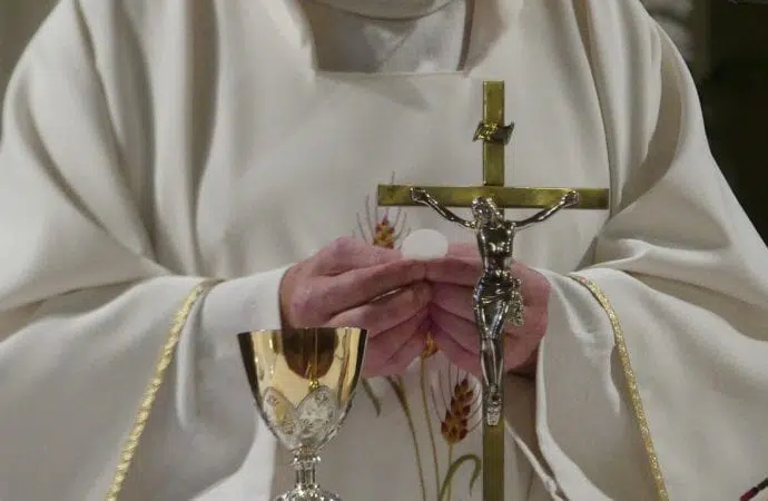 Priest holding cross